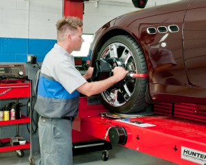 mechanic startig to tighten up bolts on a tire during typical tire rotation services
